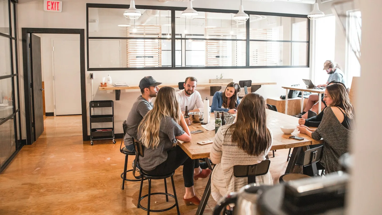 Marketing team collaborating around a table in a bright creative office.