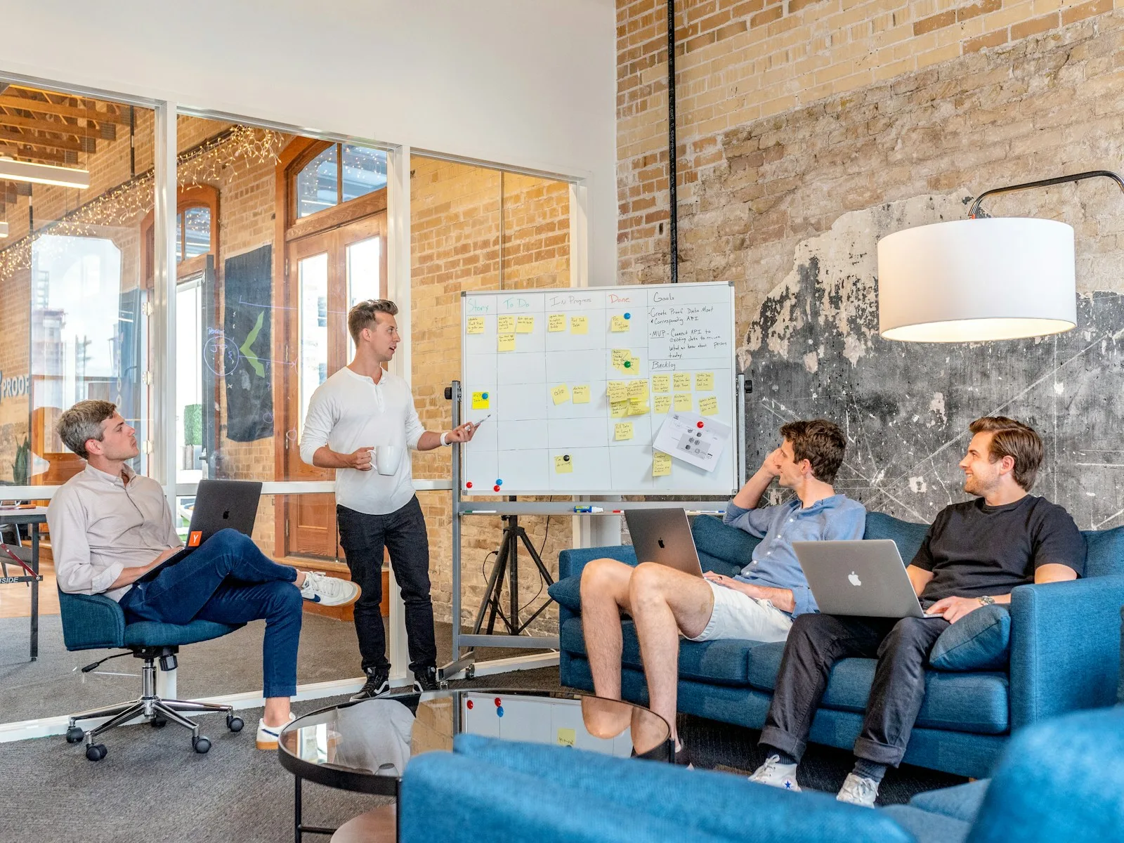 Marketing team discussing campaign strategy around a planning board.